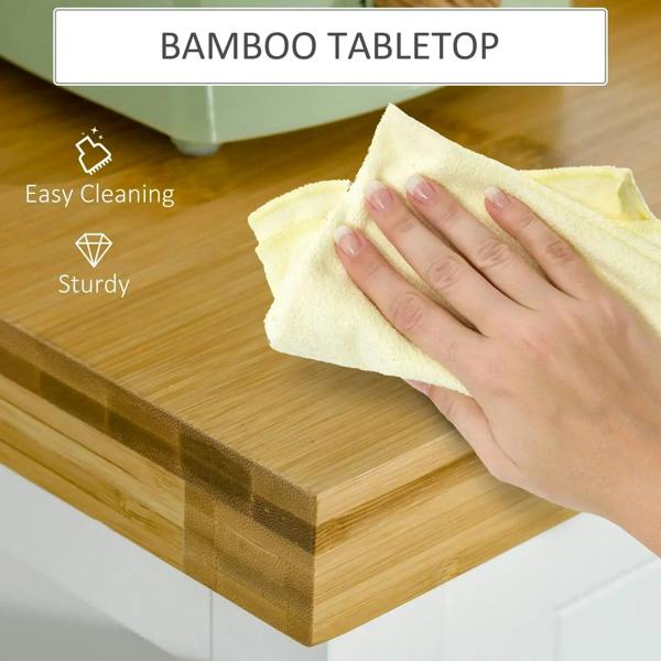 Bamboo tabletop on a white kitchen cart with cloth wiping the surface for easy cleaning