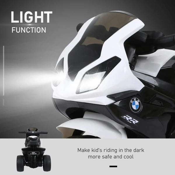 Kids electric ride-on motorbike with bright front headlight and black-and-white body styling.