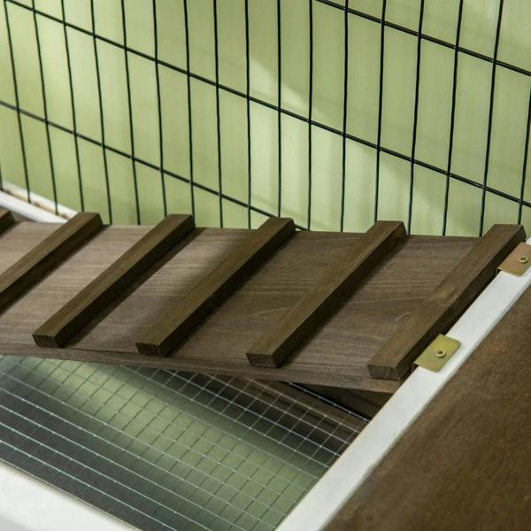 Wood ramp inside white wire rabbit hutch with wire floor grid