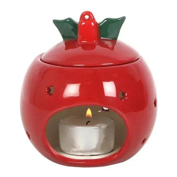 Red bauble oil burner with open candle flame and green holly cap.
