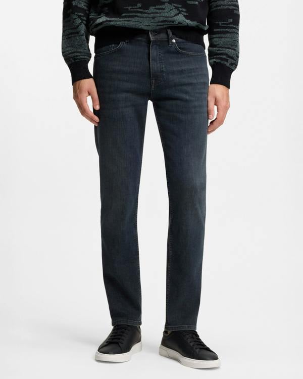 Model wearing BOSS Orange ReMaine Mens Jeans 50555289 in Dark Blue 408 - Front