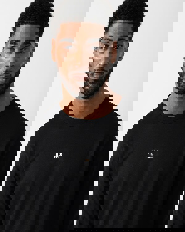 Close up shot of a Model wearing a BOSS Orange Mens Iconic Loungewear Sweatshirt in Black