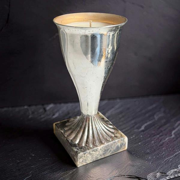 Decorative silver candle holder on a dark surface