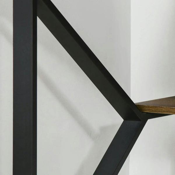 Close-up of black metal support frame under a brown wood-effect desktop