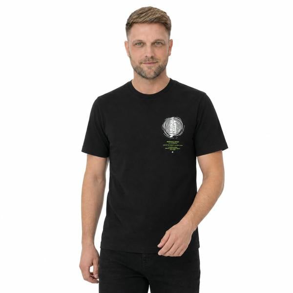 Man wearing a black Marshall Artist Space Face cotton t-shirt with a circular graphic print on the chest.
