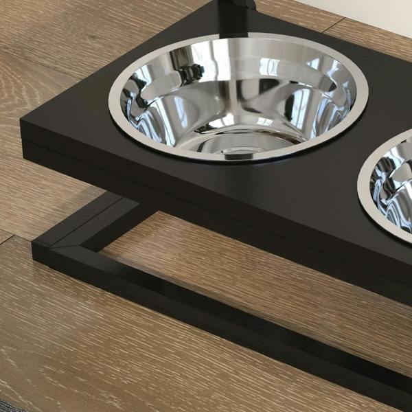 Stainless steel dog bowl in a black elevated feeder base with chrome interior