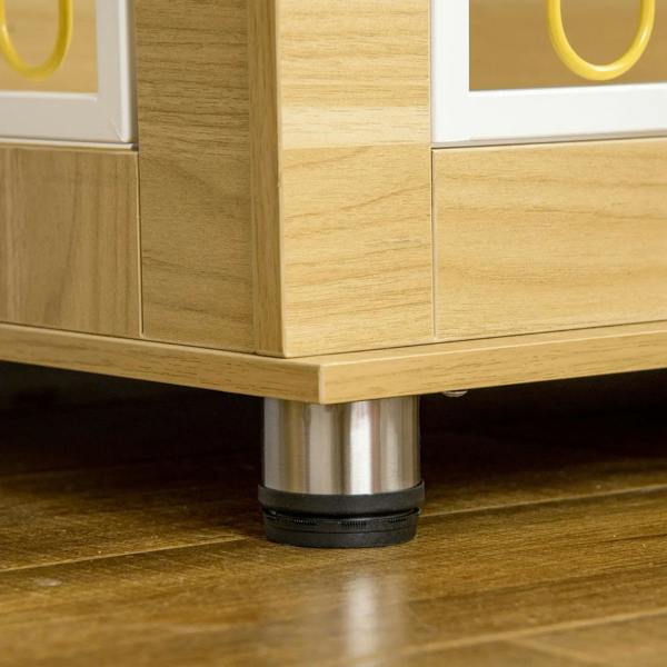 Oak-tone dog crate end table corner with metal base feet and door frame detail.