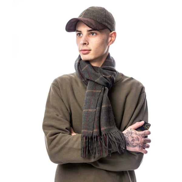 Person wearing a brown cap and scarf on a white background