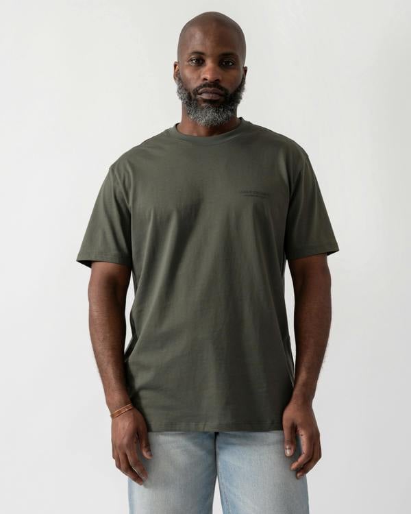 Model wearing an Armani Exchange Mens T-Shirt with Small Milano/New York Logo in Chimera