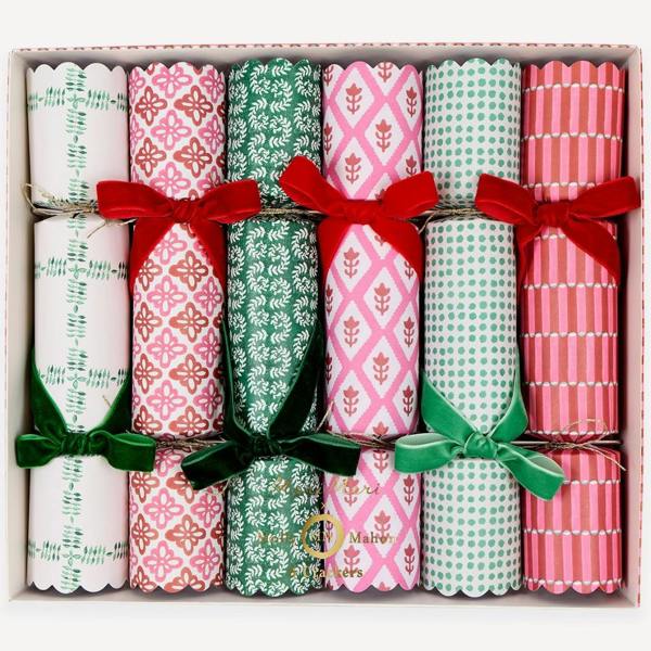 Set of six scalloped block-print Christmas crackers with red and green velvet bows in a presentation box.