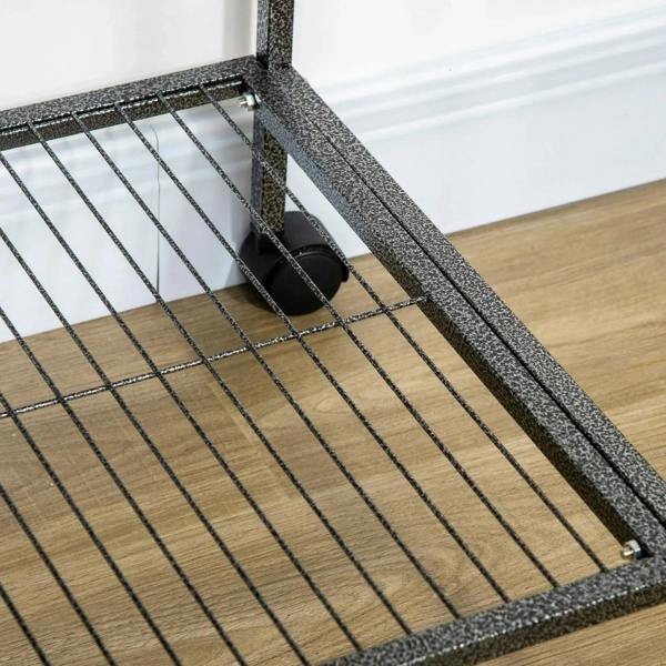Black cage base with wire grid and attached frame; close-up of lower tray area