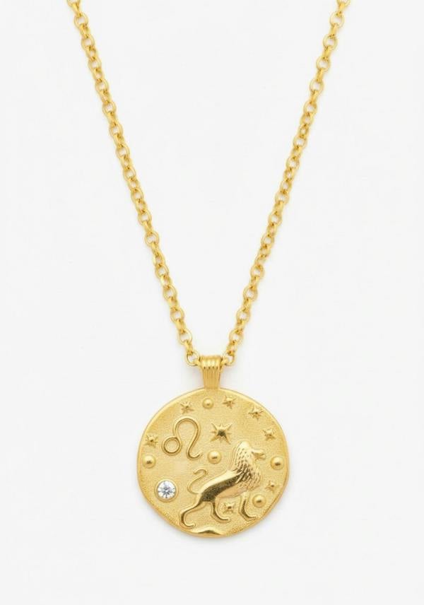 Gold necklace with a zodiac pendant on a white background