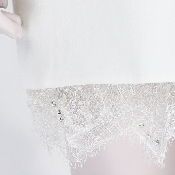 An intricate long-sleeve french lace sequin dress in white by Emilio Pucci