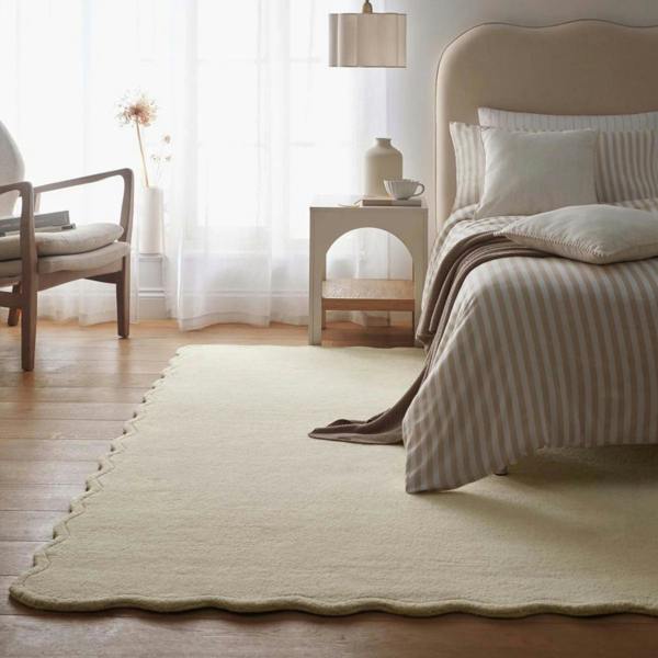 Neatly made bed with striped bedding in a bedroom setting.