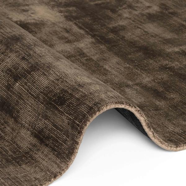 Close-up of a brown textured rug on a white background