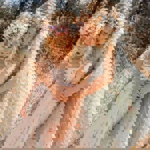 2 girls playing in pretty dresses