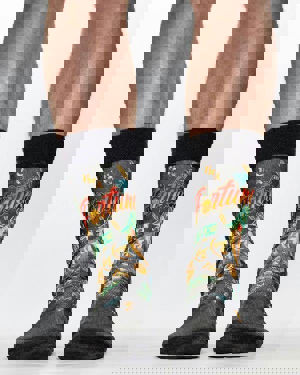 Black socks with colorful designs and 'Fortune' text worn by a person on a white background