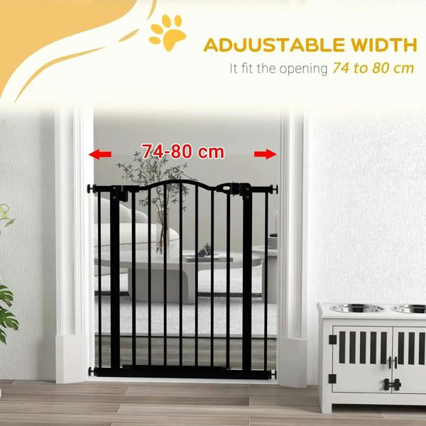 Black pet gate installed in doorway with adjustable width markings on the frame
