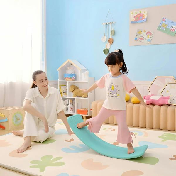 Kids wobble balance board in teal, child standing and balancing on the curved board.
