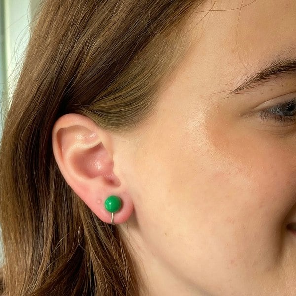 Green clip-on earrings, small round bead design, glossy green finish, silver-tone clip setting, minimalist vintage-inspired jewellery
