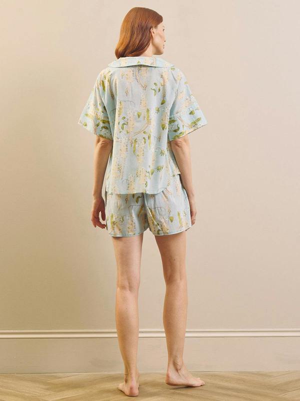 model wears a light blue and white wisteria short pyjama set. 