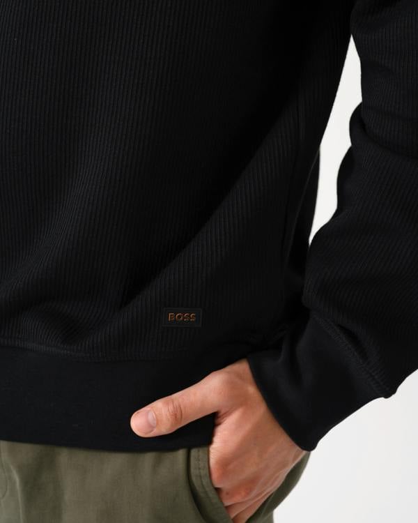 logo detail of a BOSS Orange We Urban Mens Crew Neck Sweatshirt with Pocket in Black 001