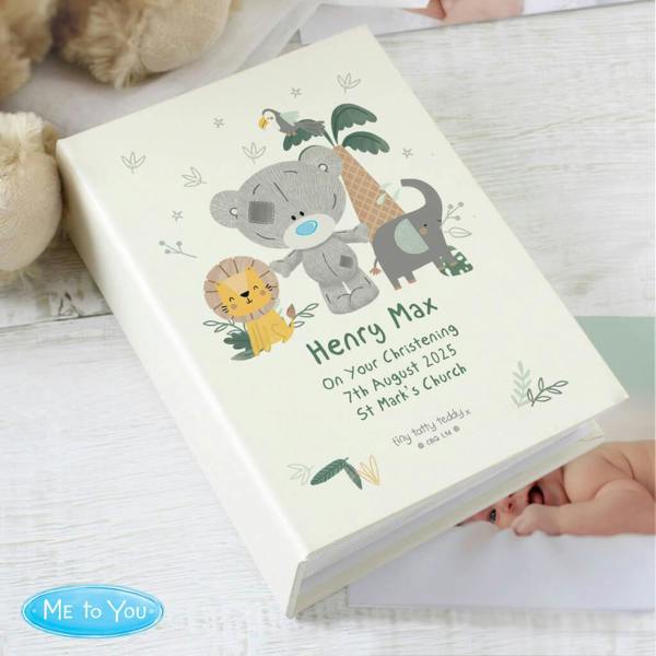 A personalised white Christening photo album featuring a jungle animal illustration of a giraffe, elephant, and lion, custom printed with the name 'Noah' and a baptism message.