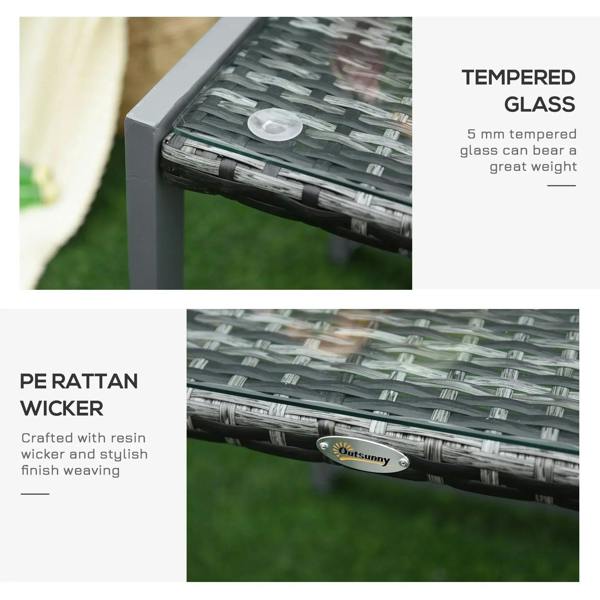 Close-up of grey rattan table corner with dark woven surface and tempered glass