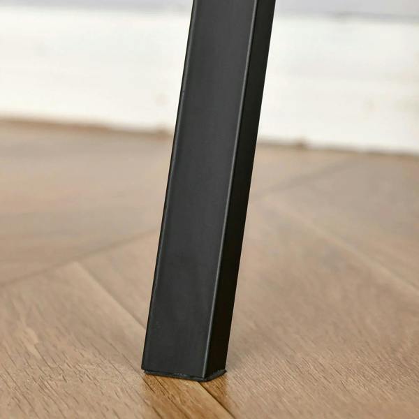 Black metal desk leg base on tabletop corner