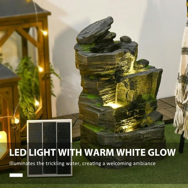 Warm white LED-lit dark grey rock water fountain with green moss accents