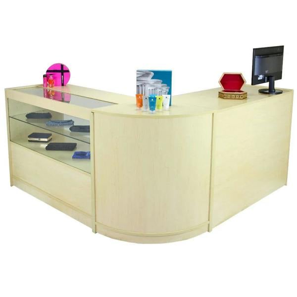 Curved maple reception desk with glass display, showcasing colorful accessories and a monitor, ideal for modern office spaces