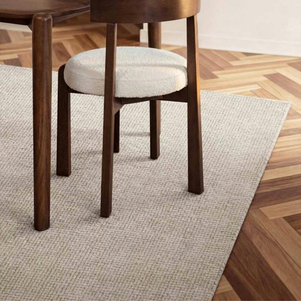 Wooden chair with a white cushion on a wooden floor