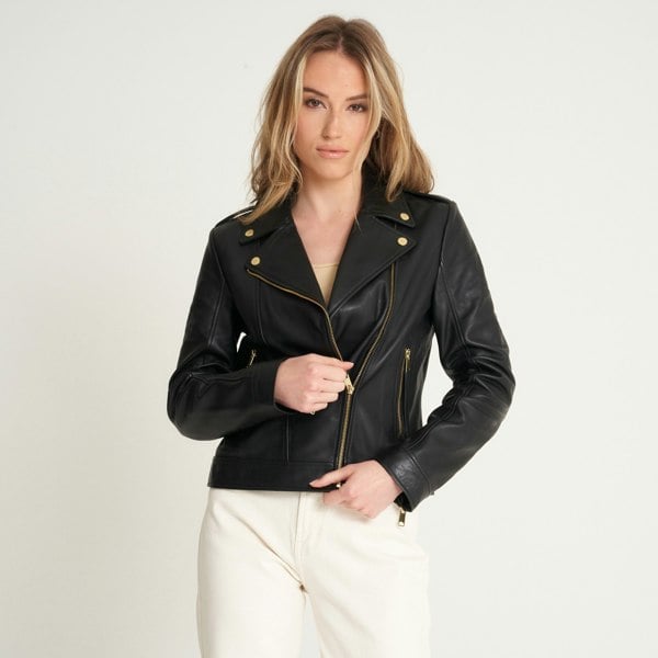 this image shows a barneys originals leather jacket zipped halfway on a blonde model.