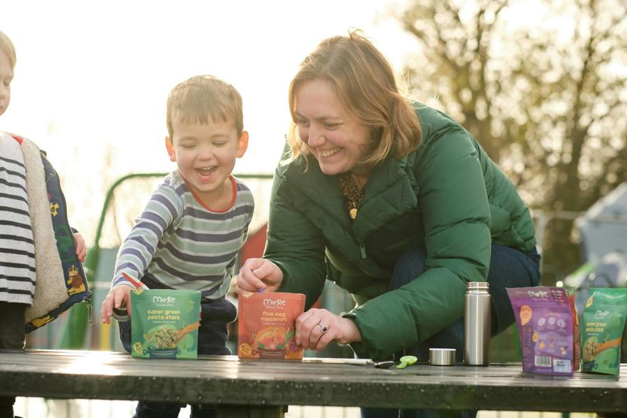 Mum and toddlers at a picnic bench preparing more toddler meals for healthy on the go meal times. 
