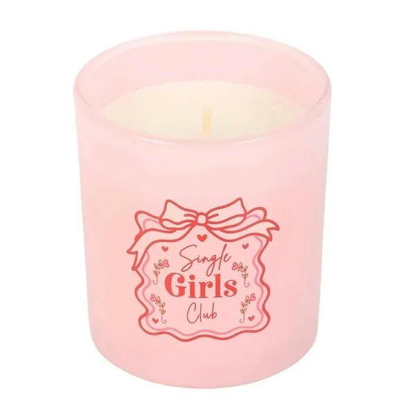 Pink cylindrical candle with “Single Girls Club” logo and visible flame