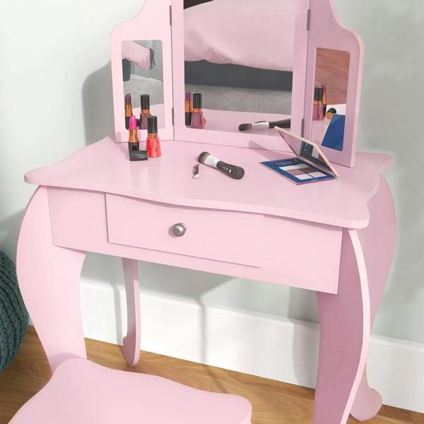 Pink kids vanity table with tri-fold mirror, drawer, and tabletop with accessories
