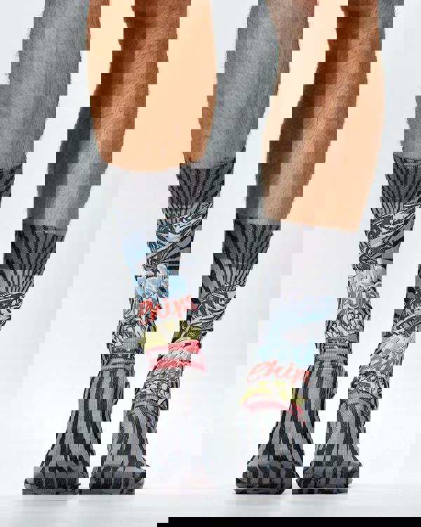 Colorful socks with abstract designs worn by a person on a white background