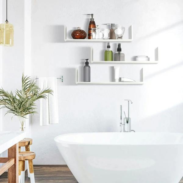 White U-shaped floating wall shelves mounted near a sink with open storage compartments