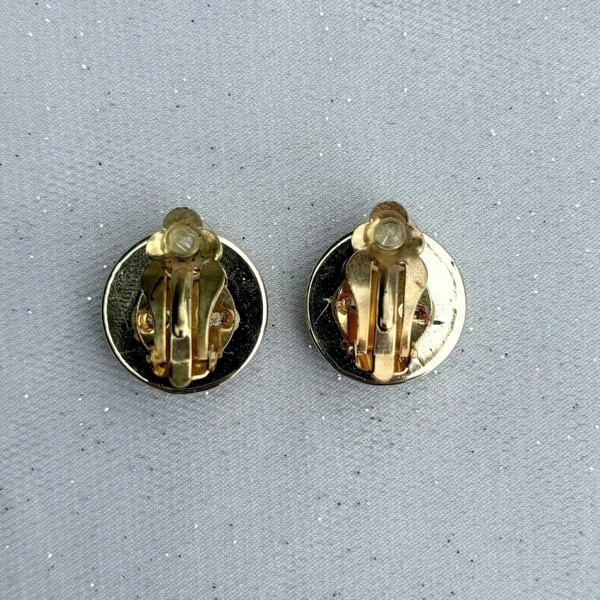 Red and gold clip-on earrings, round dome design, glossy red centre, gold-tone border, bold statement jewellery, vintage-inspired accessory
