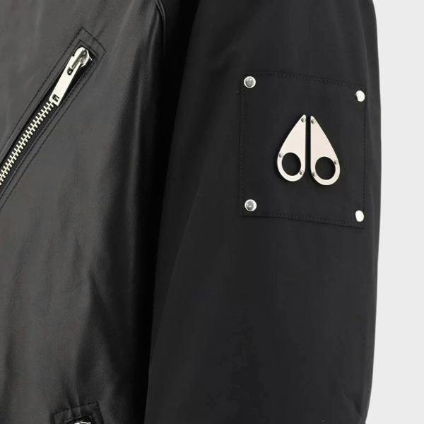 Supplied Fashion Anica black leather bomber jacket featuring a metal logo patch on the sleeve and silver zipper detail.