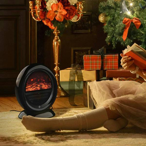 Black tabletop electric fireplace heater glowing with flame effect near seated cushions