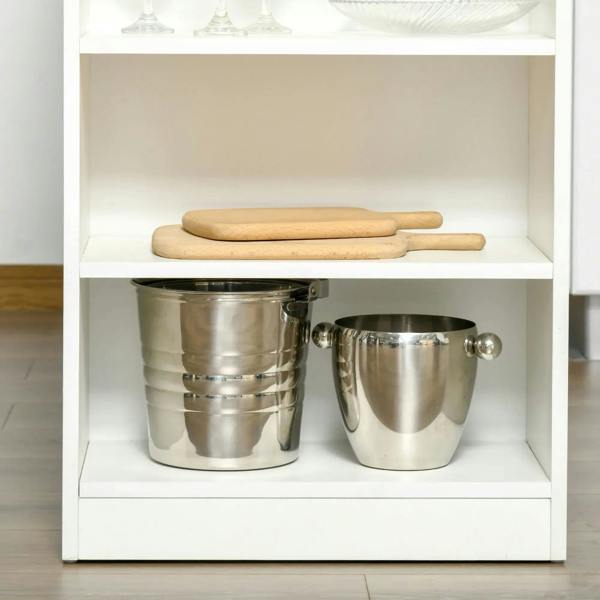 Open storage shelf compartment on a white bar table holding metal buckets and wooden boards.