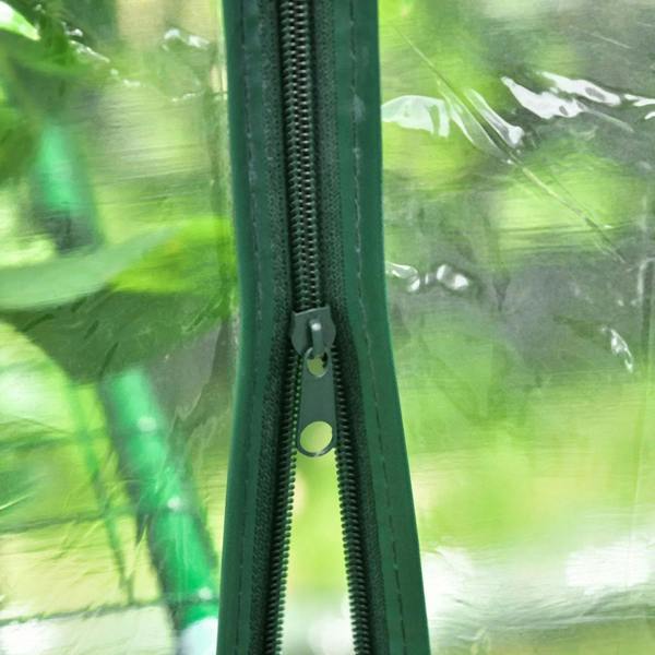 Walk-in greenhouse zipper close-up on green steel frame, track and pull tab visible