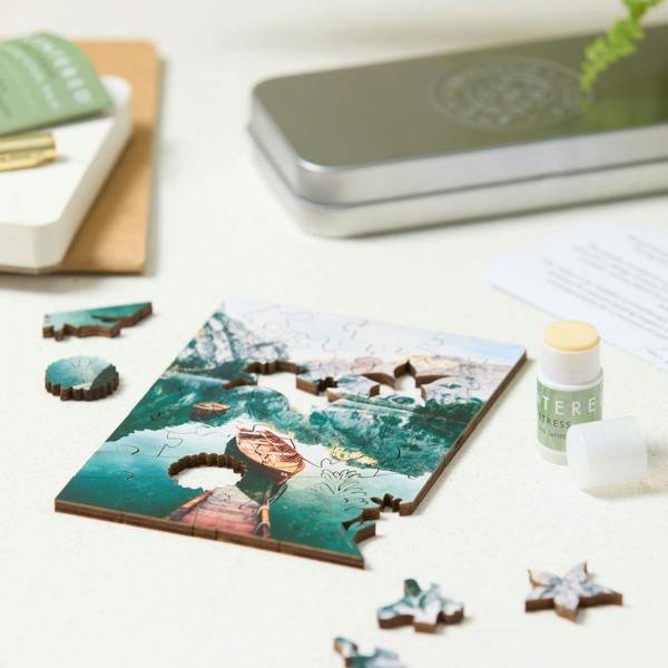 Scentered De-stress  change of pace set, puzzle nearly completed and balm with lid off.