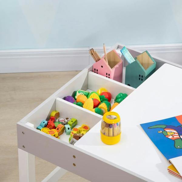 Grey kids table with open side storage bins filled with toys