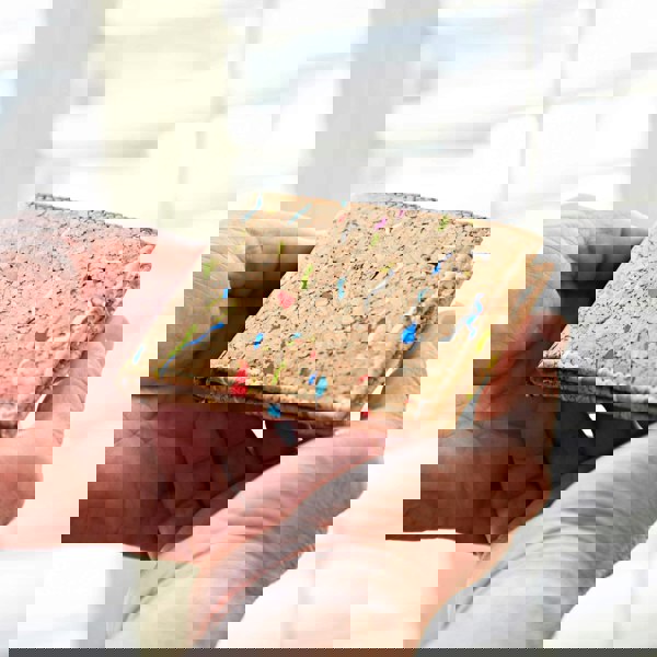 A man's hand holding a Natural Cork Billfold Wallet.