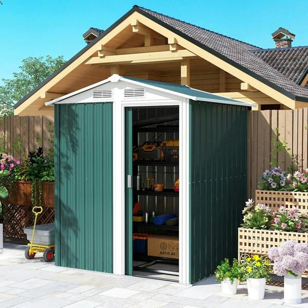 Green metal garden storage shed with sliding door open and visible shelving inside