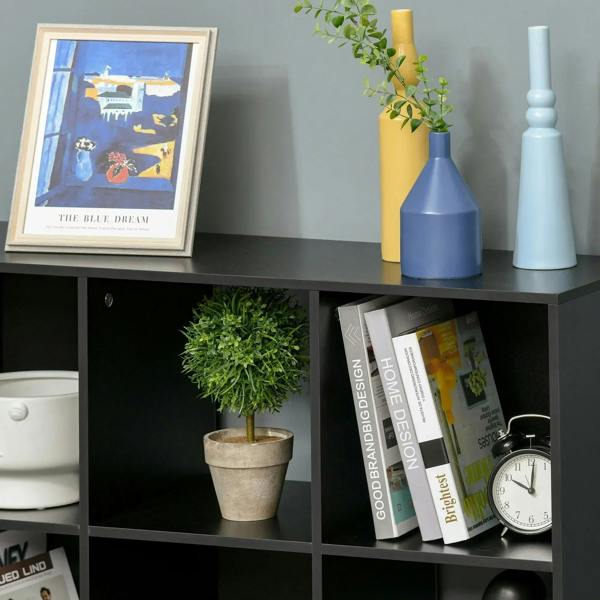 Black 9-cube storage unit with open shelves, displaying decor, books, and a clock