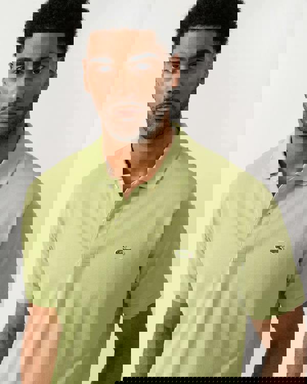 close up shot of a model wearing a Lacoste Classic Fit L.12.12 Mens Short Sleeve Polo Shirt in Birch UYB