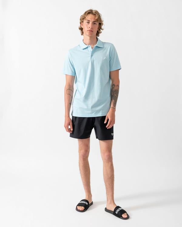 model wearing a pai of Emporio Armani Mens Swim Shorts with Eagle Logo in Black